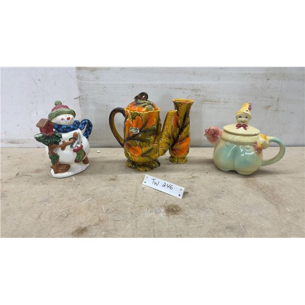 Three Ceramic Teapots Including Snowman, Autumn Leaves, and Jester Figural Designs