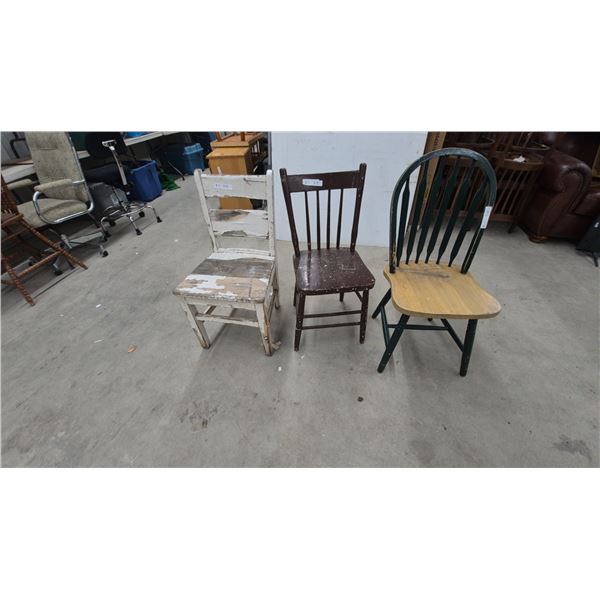 Three Distressed Wooden Chairs: White Ladder-Back, Brown Spindle-Back, Green Windsor-Style