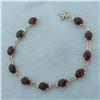 Image 1 : Fancy Checkerboard Cut Garnet And Diamond Bracelet in 10k Yellow Gold