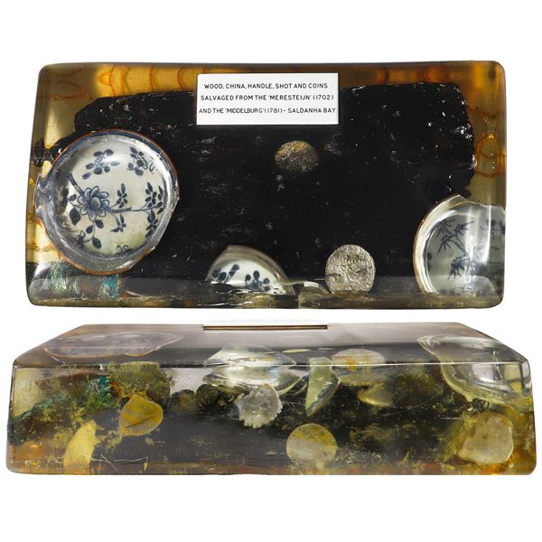 Large resin block containing four Dutch silver ducatoons, four Chinese porcelain shards, four musket
