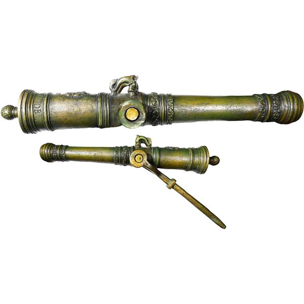 Small copper imitation swivel cannon dated "1619," with yoke.