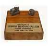 Image 1 : Lead musketball and small piece of ballast stone on a wooden display with plaque, ex-1733 Fleet ("Tr