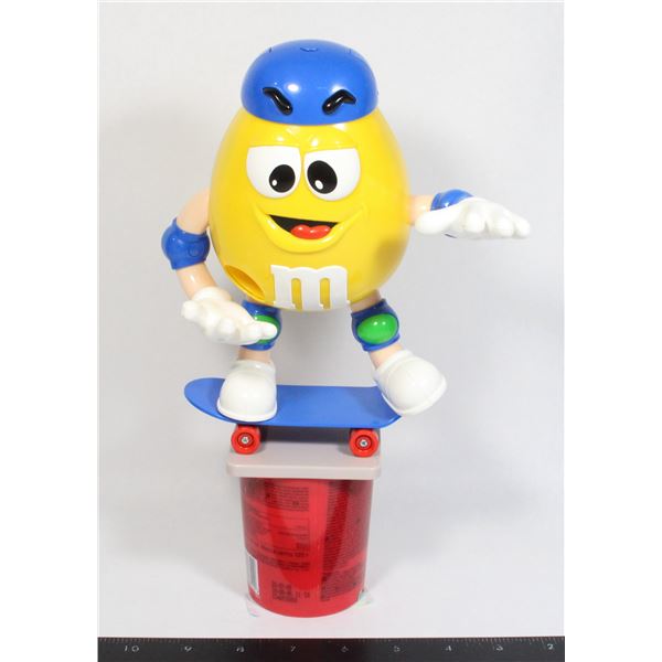 YELLOW M&M ON A SKATEBOARD CANDY DISPENSER