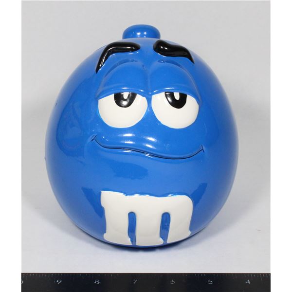 CERAMIC M&M JAR FEATURING BLUE WITH SOME CHIPS TO