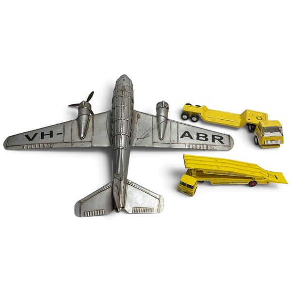 Silver Airplane Toy with Three Yellow Toy Trucks