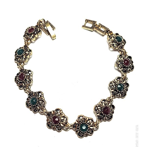 14)  ANTIQUED GOLD TONE WITH EMERALD