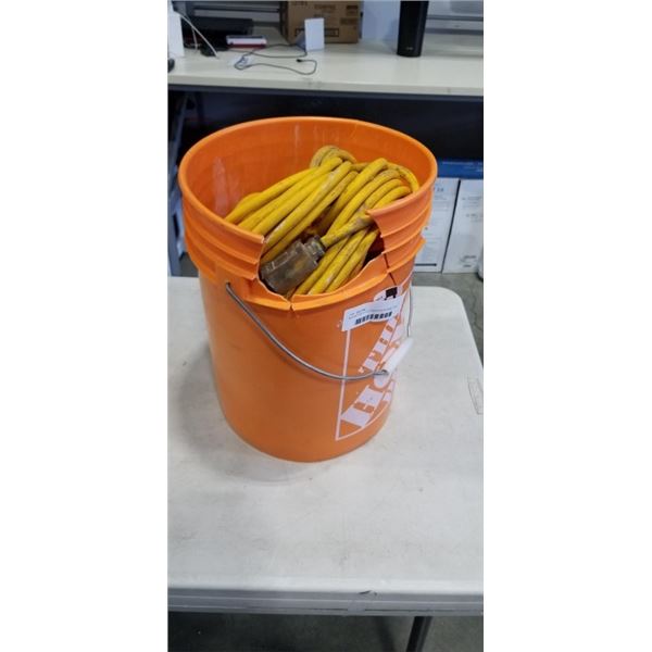 BUCKET WITH 4 EXTENSION CORDS. ONE HAS 3 OUTLET