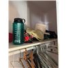 Image 5 : Closet Contents Including Table, Pink Stethoscope, Water Bottle, Hangers, and Bags