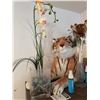 Image 13 : Wood and Glass Shelf Unit With DVDs, Remote Controls, Plush Tiger, and Decor Items