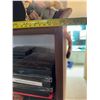 Image 15 : Wood and Glass Shelf Unit With DVDs, Remote Controls, Plush Tiger, and Decor Items