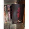 Image 3 : Wood and Glass Shelf Unit With DVDs, Remote Controls, Plush Tiger, and Decor Items