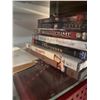Image 4 : Wood and Glass Shelf Unit With DVDs, Remote Controls, Plush Tiger, and Decor Items