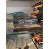 Image 7 : Wood and Glass Shelf Unit With DVDs, Remote Controls, Plush Tiger, and Decor Items