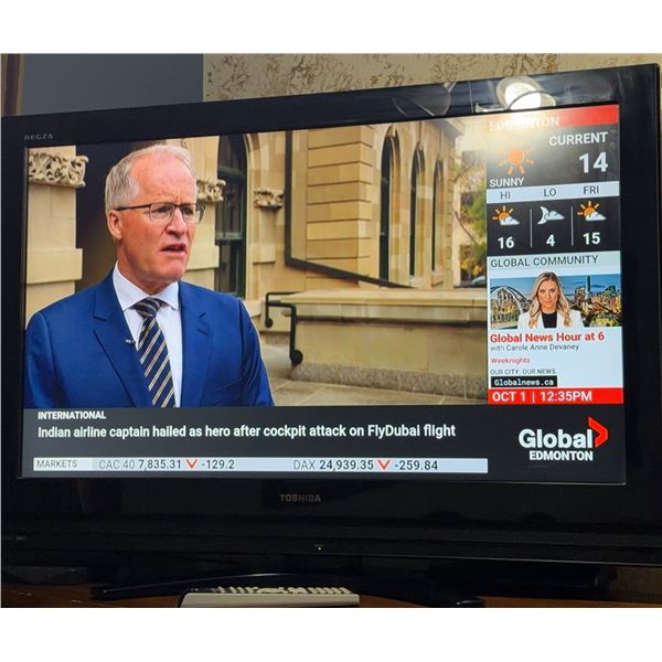 Toshiba Flat Screen TV with Remote Control Displaying Global Edmonton News Broadcast