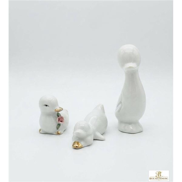 Three Ceramic Duck Figurines with Gold Accents