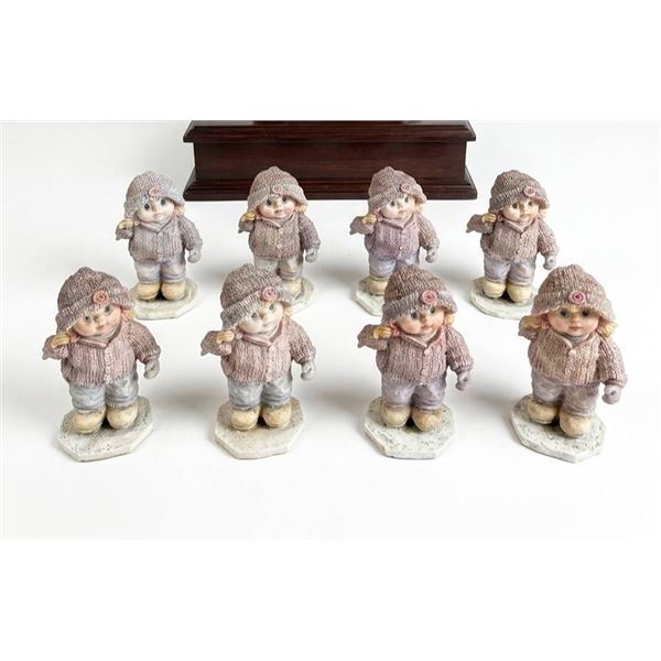 8 Porcelain Girl Figurines in Winter Clothing