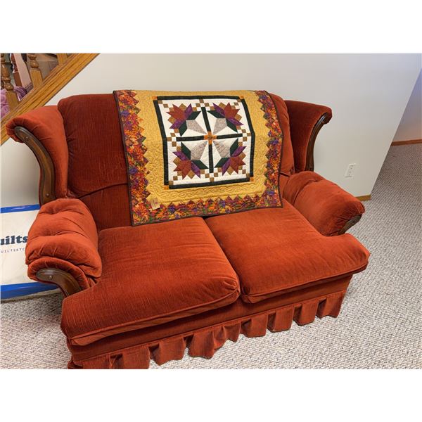 Rust Upholstered Loveseat with Skirted Base