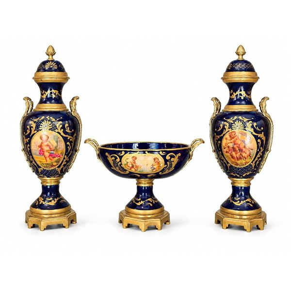 Spanish Sèvres. Three Cobalt Blue Porcelain Vases with Gilded Accents and Painted Scenes