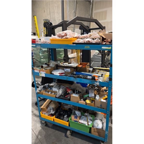 RACK OF PLUMBING FITTINGS AND SUPPLIES INCL COPPER FITTINGS TOTES CAULKING GUNS ADHESIVE SEALANT