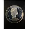 Image 2 : 1982 Canada Regina Dollar, 23g .500 Silver, Queen Elizabeth II/Skull and Parliament Building