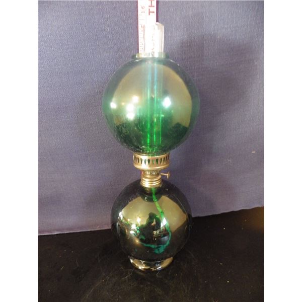 appears to be a vintage green glass coal oil Lamp