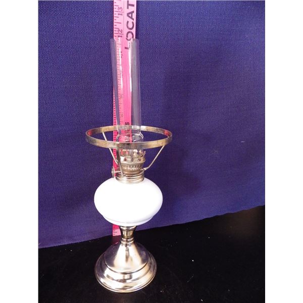 Collectible coal oil lamp with white  body and metal stand