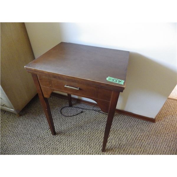 Singer sewing machine in cabinet