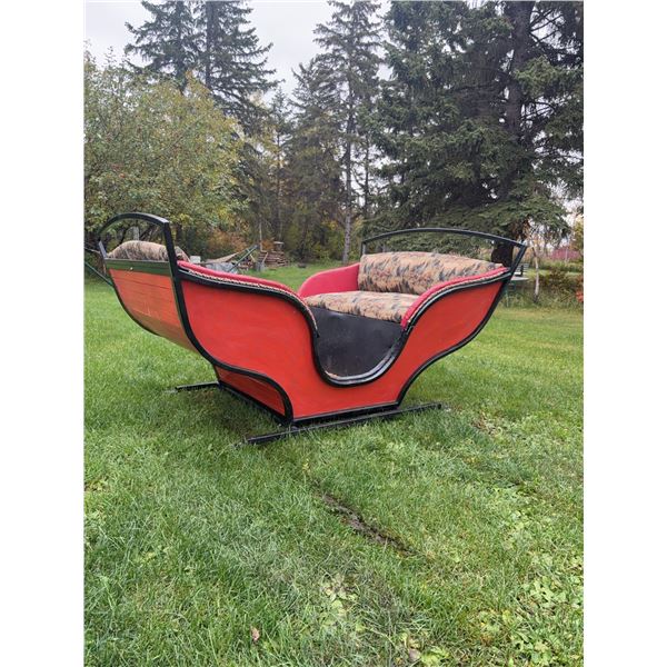 Red Horse-Drawn Sleigh with Upholstered Seats and Metal Runners
