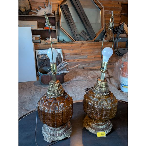 Pair of vintage mid-century modern textured amber glass table lamps with  metal bases. Likely 1970s.