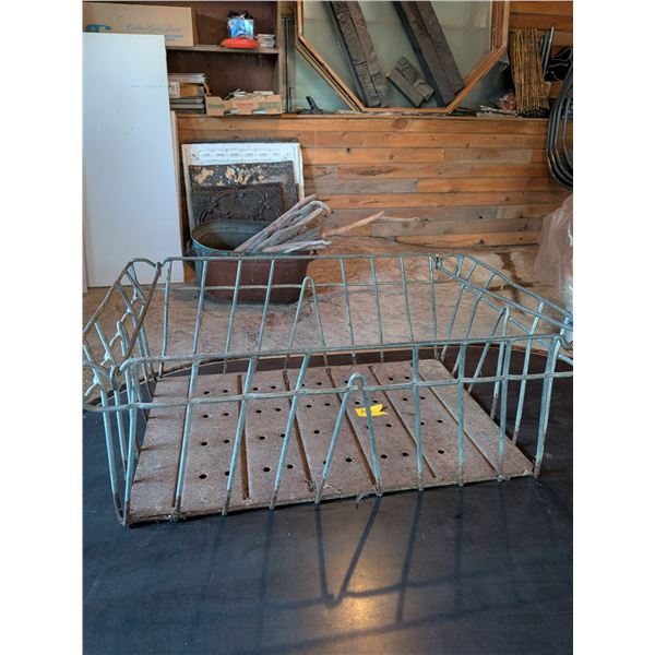 Vintage metal wire milk bottle crate with solid, perforated metal bottom.