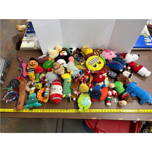 Assorted collection of plush, squeaky, and rope dog toys .