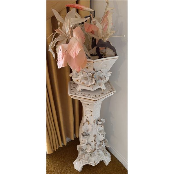 White Ceramic Plant Stand With Relief Floral Detail and Artificial Flower Arrangement
