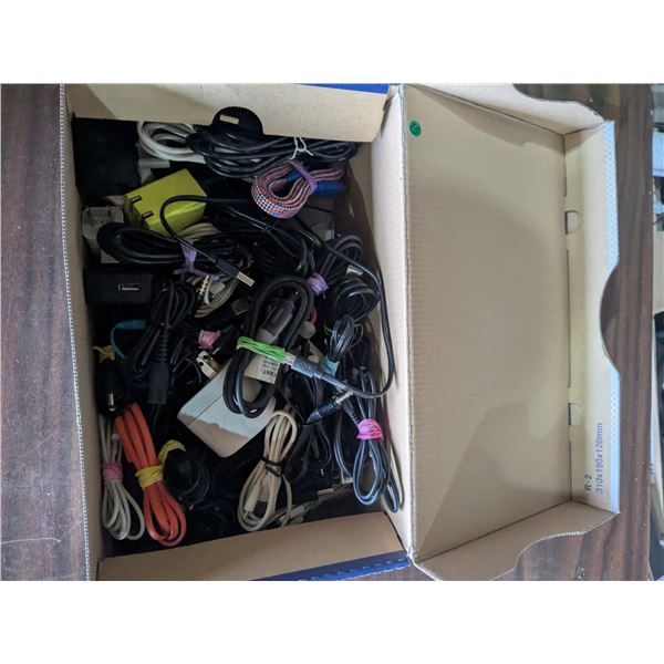 Box of assorted phone chargers, USB cxables, aux cables, etc.