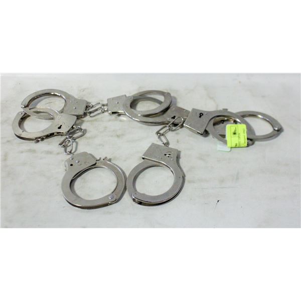 4 PAIRS OF HANDCUFFS - OPEN BUTTON ON CUFFS