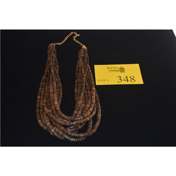 10 STRAND NECKLACE, FEATURES THIN, DISK SHAPED NEISHI BEADS CRAFTED FROM NATURAL COCONUT SHELLS (30"