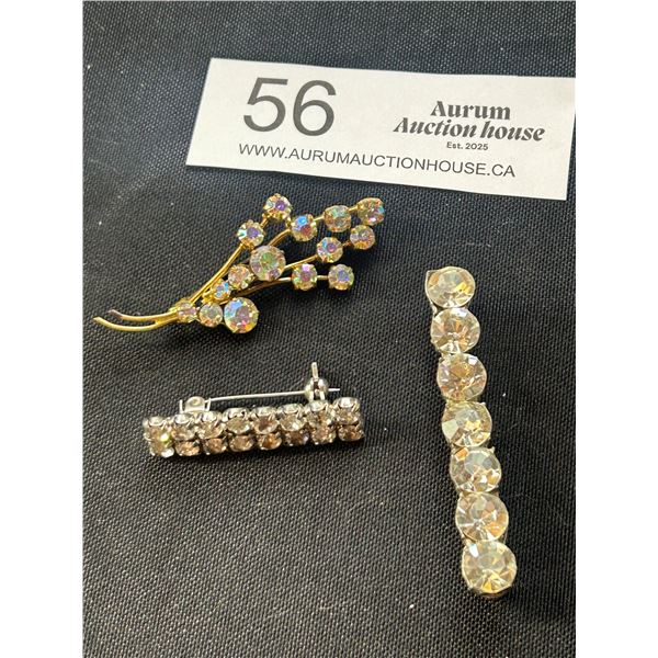 A Gold Tone Aurora Borealis Leaf Brooch Plus Two Rhine Stone Brooches