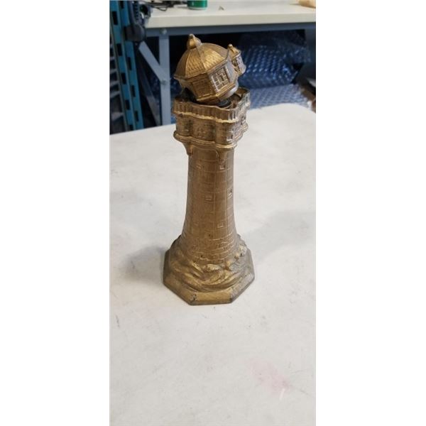LIGHTHOUSE TABLE LIGHTER. HAS A BROKEN HINGE
