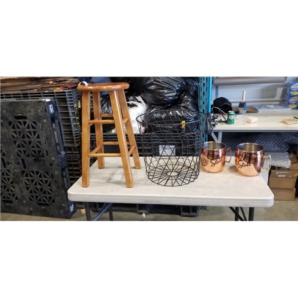 PAIR OF MULE COPPER MUGS IN BLACK WIRE STORAGE BASKET AND WOODEN STOOL