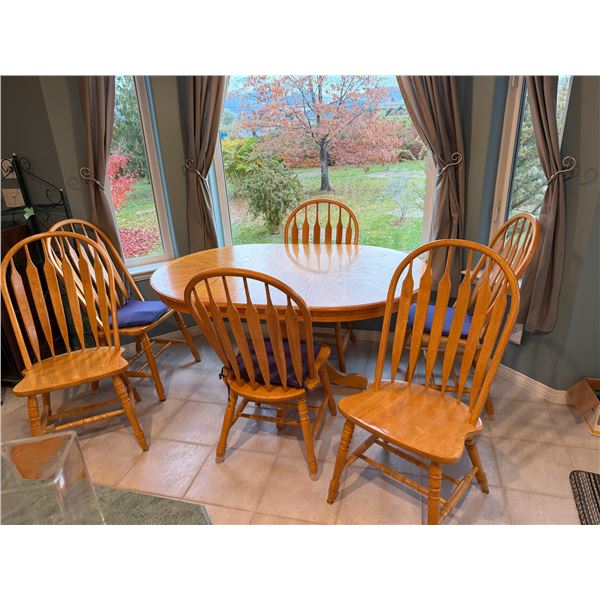 Table with six chairs and one leaf 5 feet long with leaf in 42 inches without 42 inches wide round w