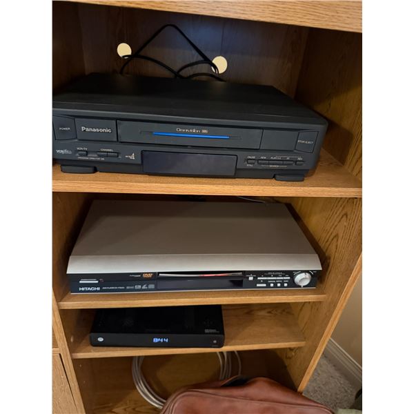 Panasonic, VHS player, Hitachi, DVD player and Motorola Box with remote remotes
