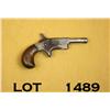 Image 1 : Small unmarked single shot derringer, .22 cal.,  2-1/2” barrel, nickel finish, wood grips, #NVSN.  T