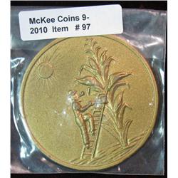 97. Iowa Tall Corn Medal. Depicts a farmer using a ladder to get to the ears.