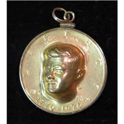 423. 1976 Gold-plated Punchout Kennedy Half Dollar in a bezel for a necklace.