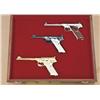 Image 1 : Colt Woodsman factory engraved 3-gun set in  presentation display case inscribed on top “Built  expr