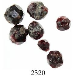 Lot of 7 roughly faceted garnets.
