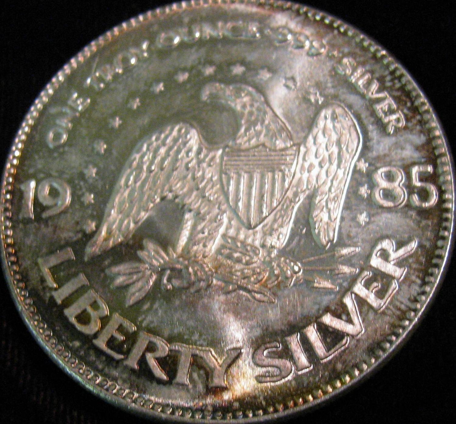 1541. 1985 Life Liberty Happiness AMark One Ounce .999 Fine Silver Round.