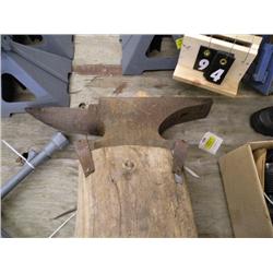 anvil on piece of wood