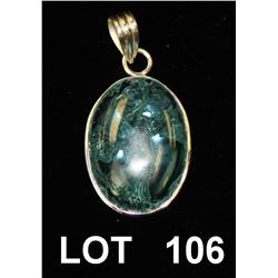 Oval blue topaz carving bezel set in a silver  frame as a pendant. Est: $200 - $400