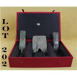 Lot of three Chinese bronze implements circa  1,500-3,000 years old contained in a lined  display bo