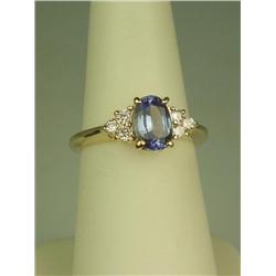 Splendid 14 karat yellow gold ladies ring set  with a center oval cut Tanzanite weighing  approx. 1.